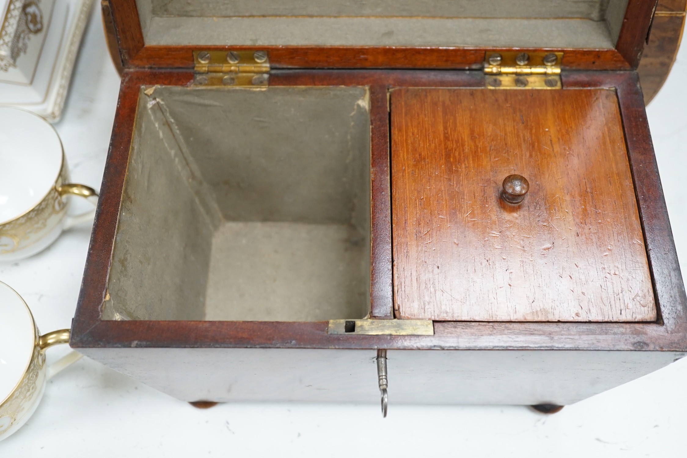 A Victorian boxwood strung burr yew sarcophagus shaped tea caddy, another mahogany tea caddy, a brass bound mahogany silver box with Bramah lock and another mahogany box. Largest 40cm wide